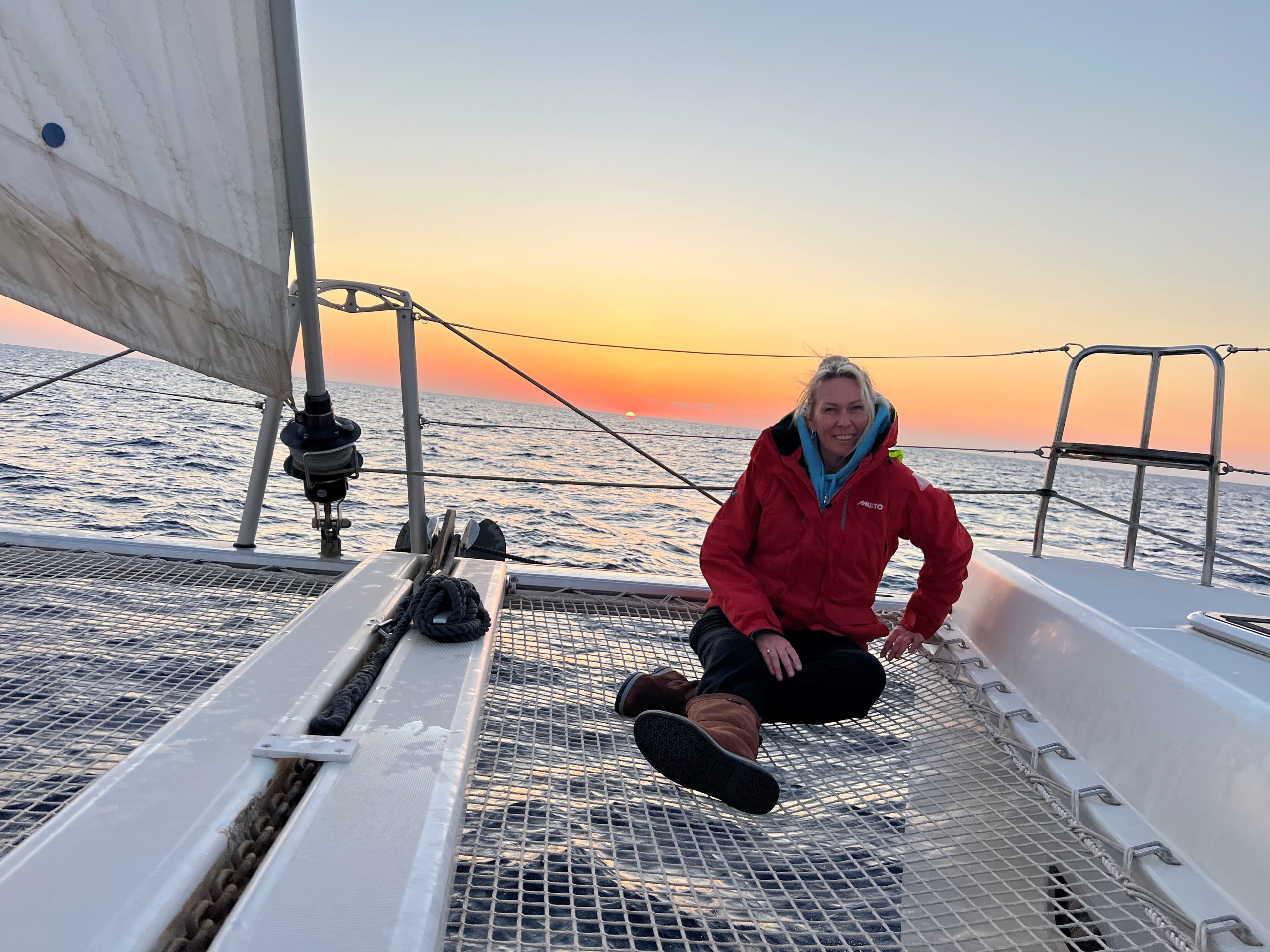 Rachel on RaRa’s foredeck at sunset while leaving Greece