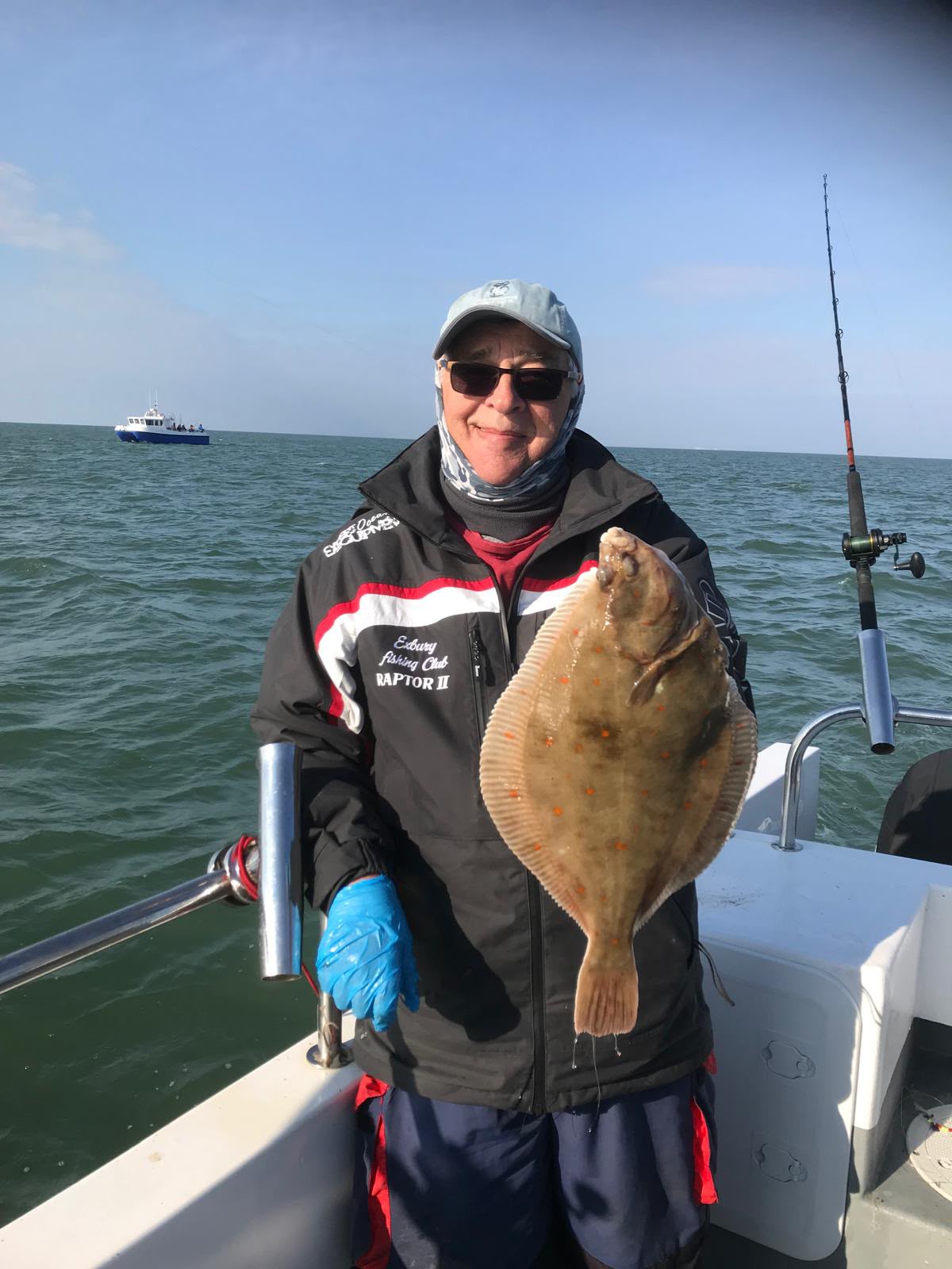 Angler displaying a flatfish aboard Raptor