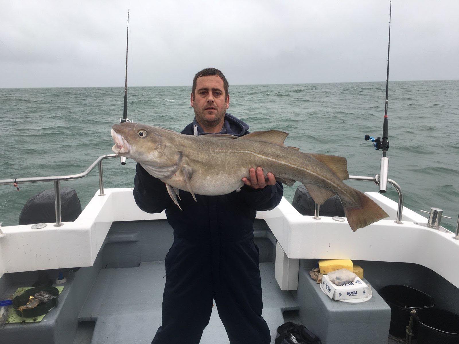 Angler displaying a large catch on the fishing boat