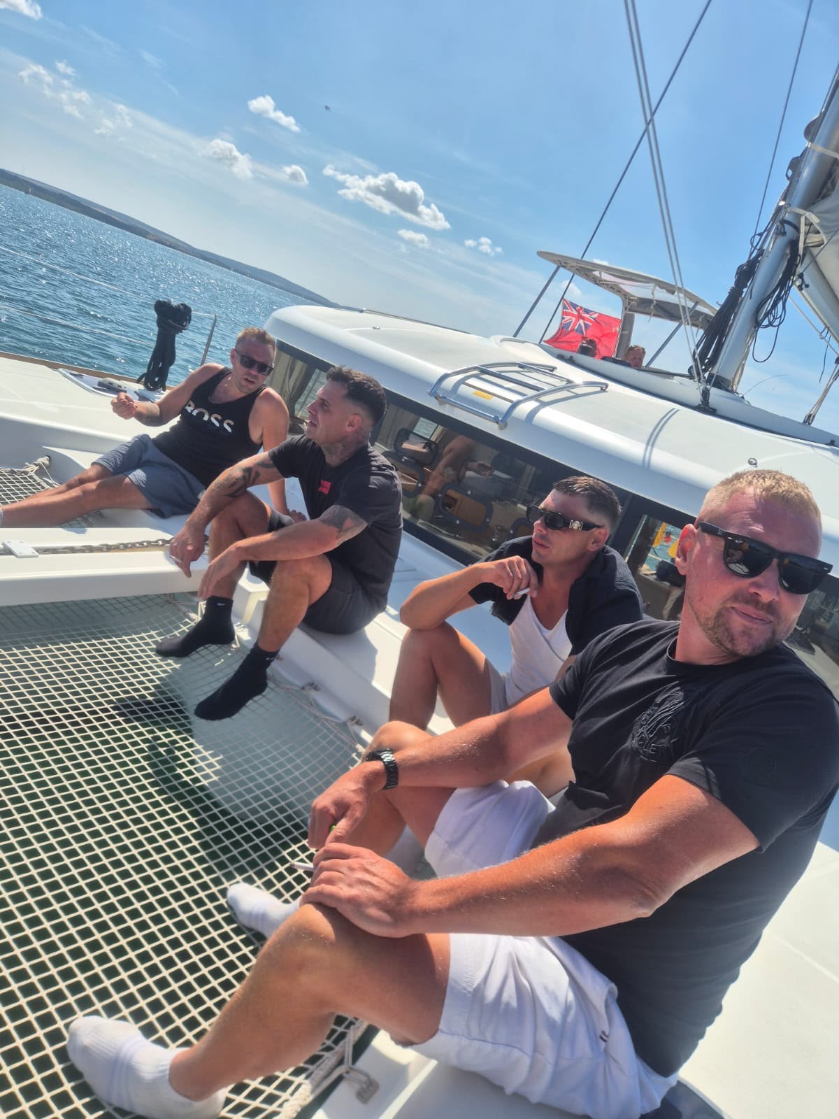 Friends relaxing on the bow nets