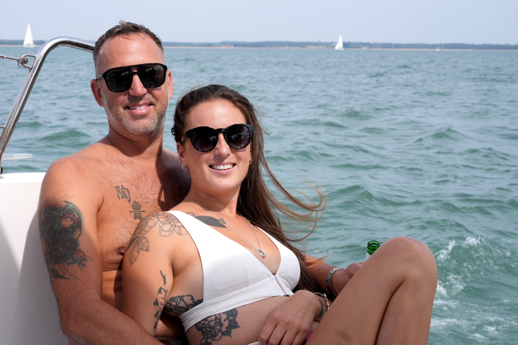 Couple relaxing with the Solent behind them