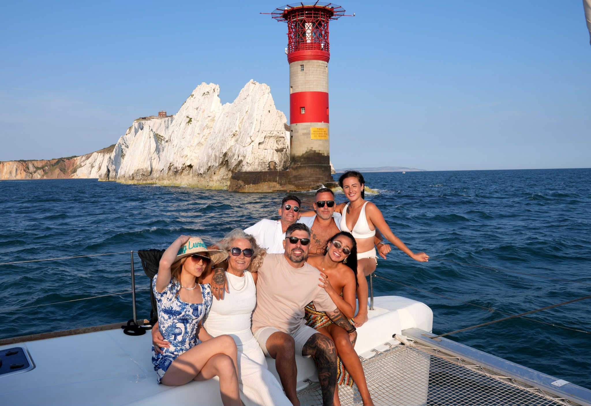 Guests posing in front of the Needles lighthouse