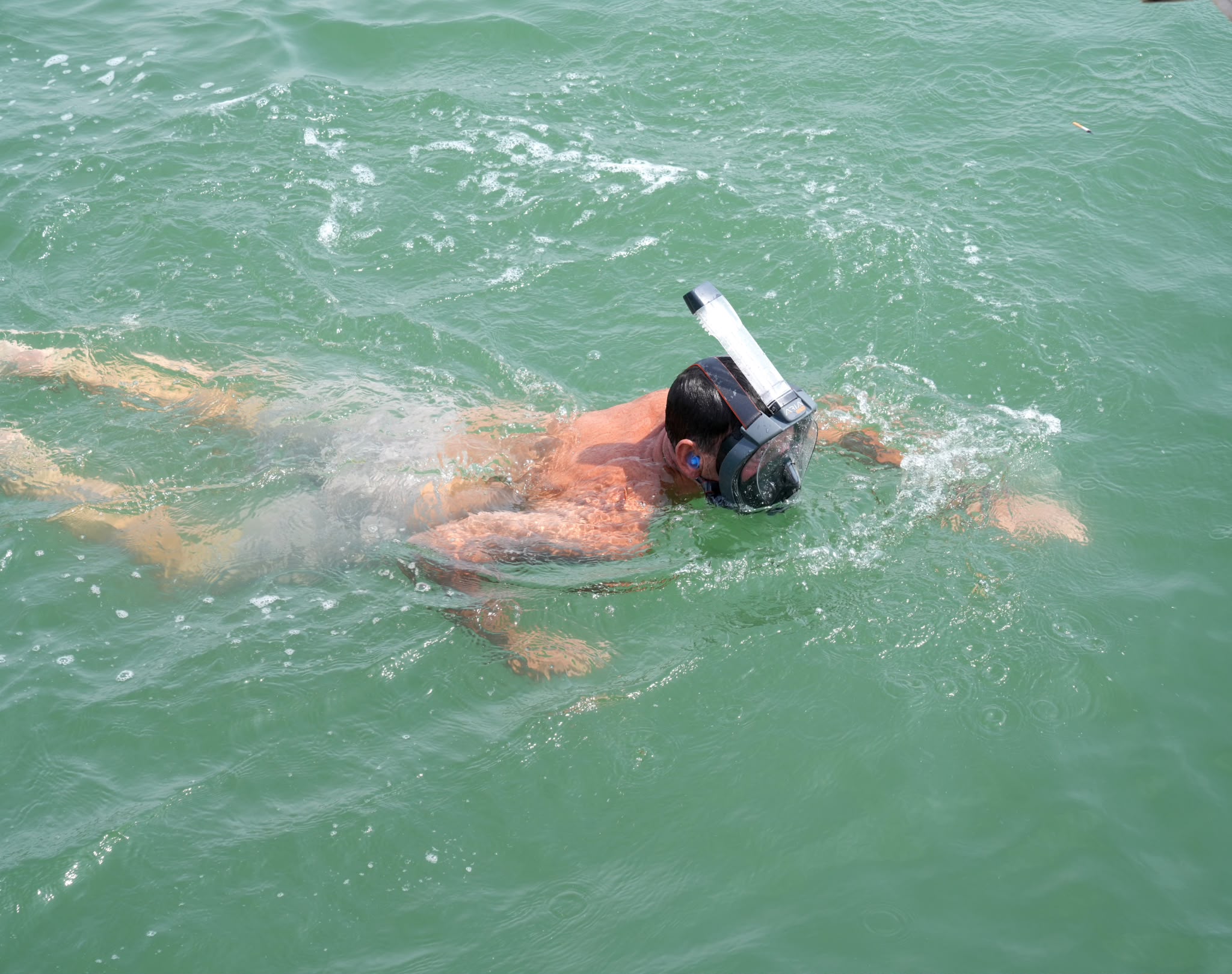 Guest snorkelling beside the boat