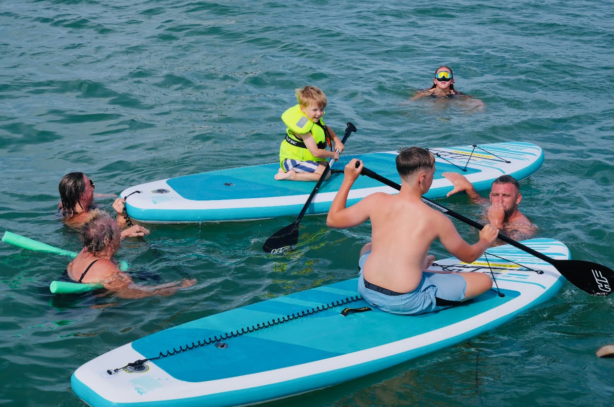 Family enjoying paddleboards together
