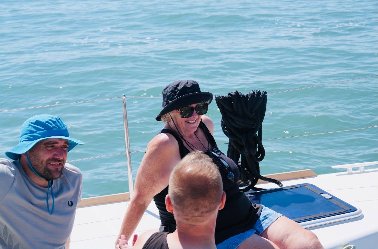 Guests smiling on the foredeck
